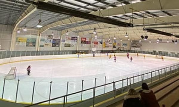 hockey players playing at an indoor arena