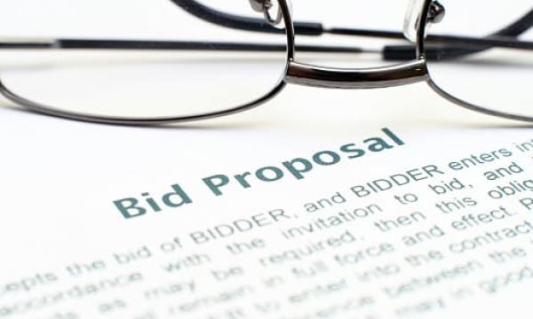 bid proposal with glasses sitting on top
